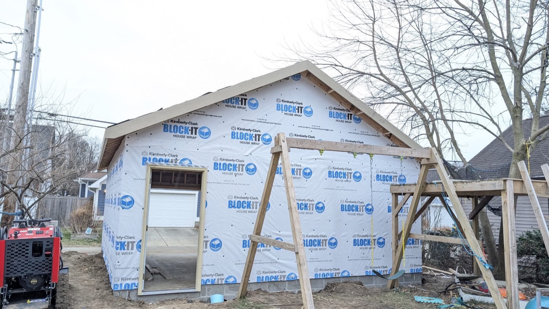 New home under construction with house wrap and gable framing