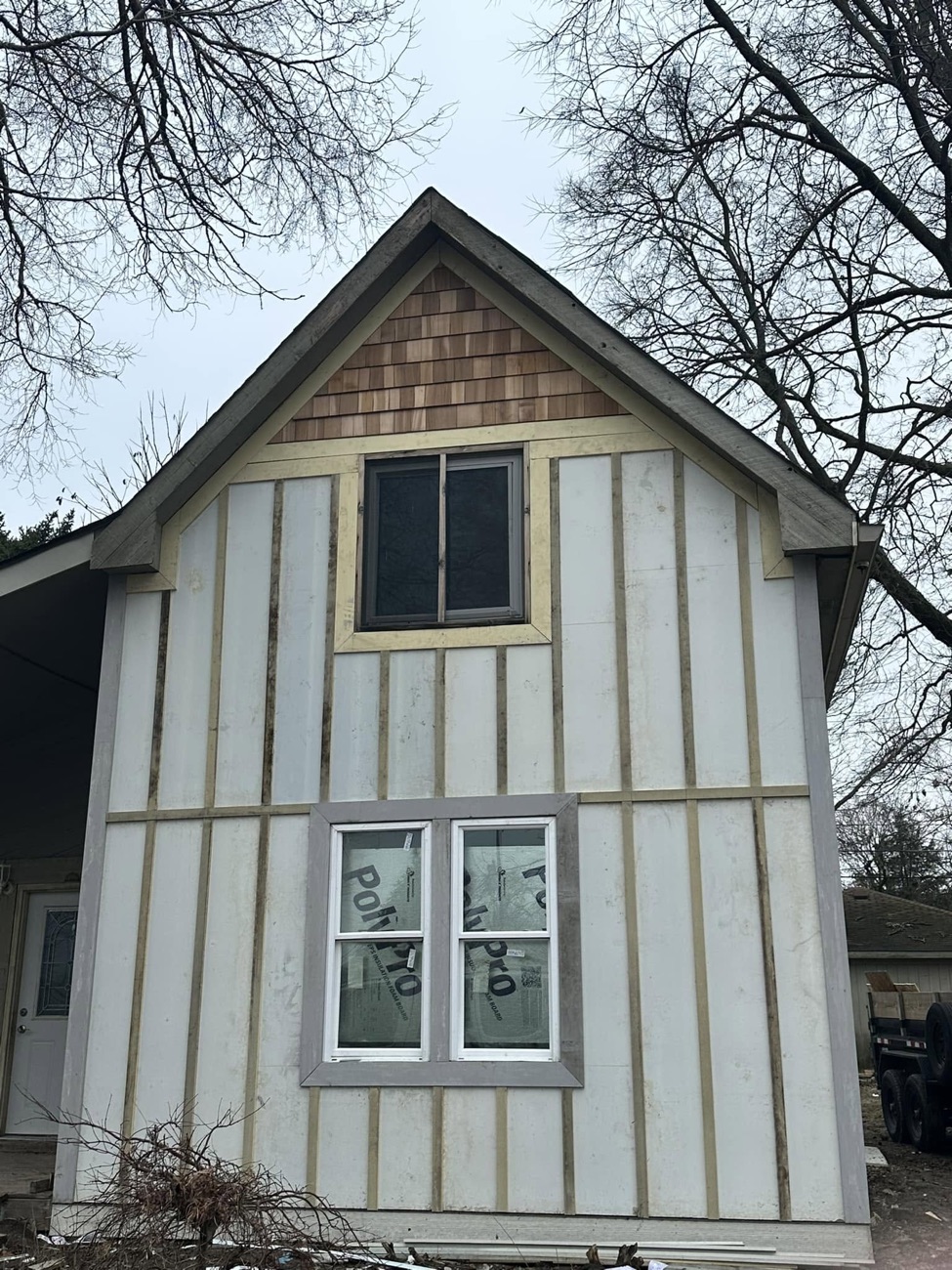 Home with new board-and-batten siding and cedar shake accent