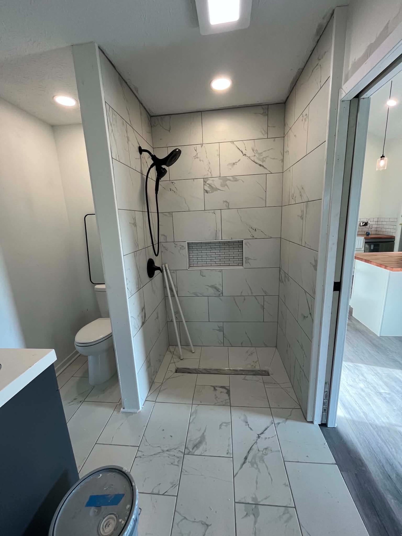 Finished bathroom with tiled walk-in shower and glass door