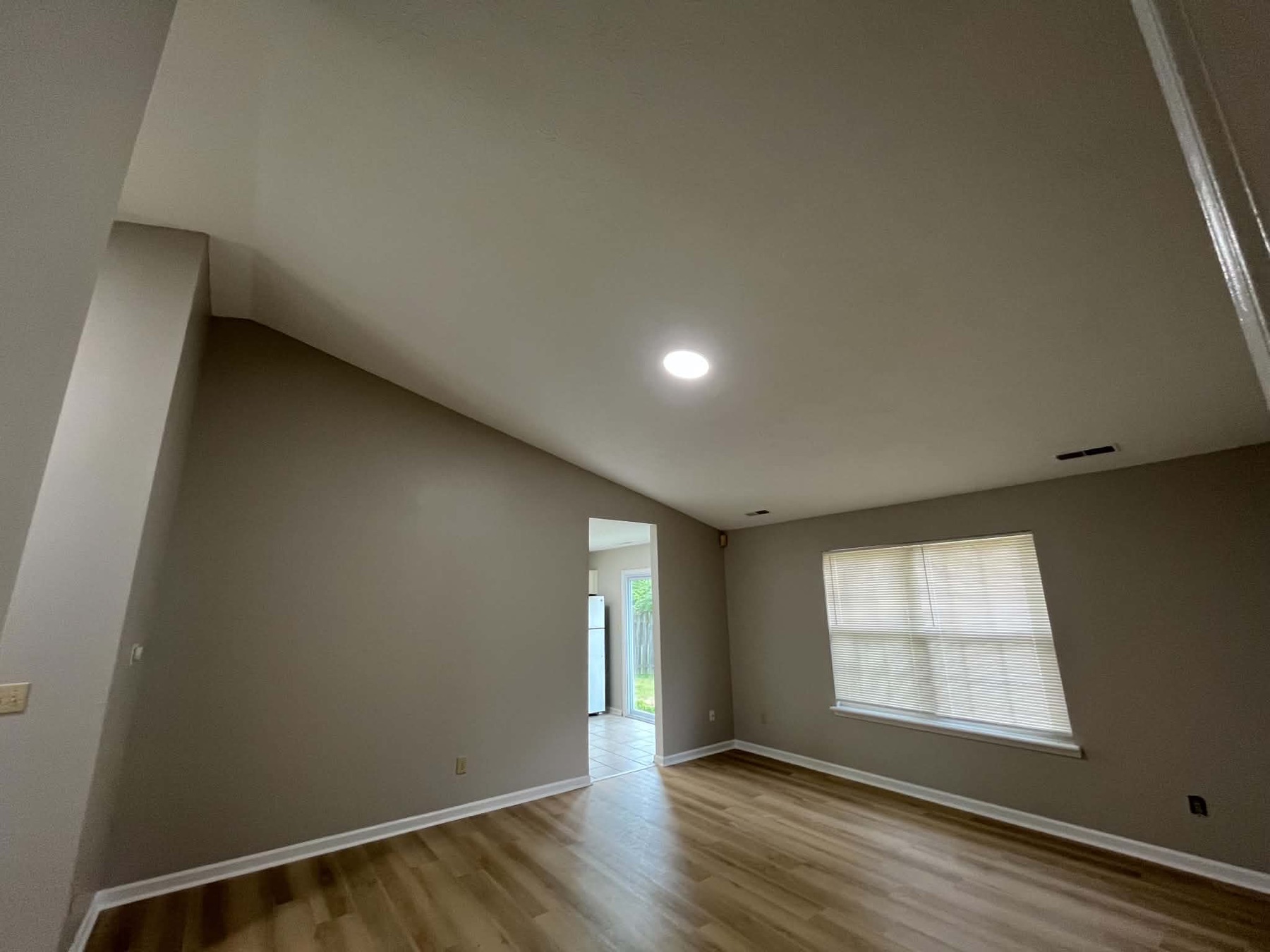 Finished living space with new hardwood floors and recessed lighting